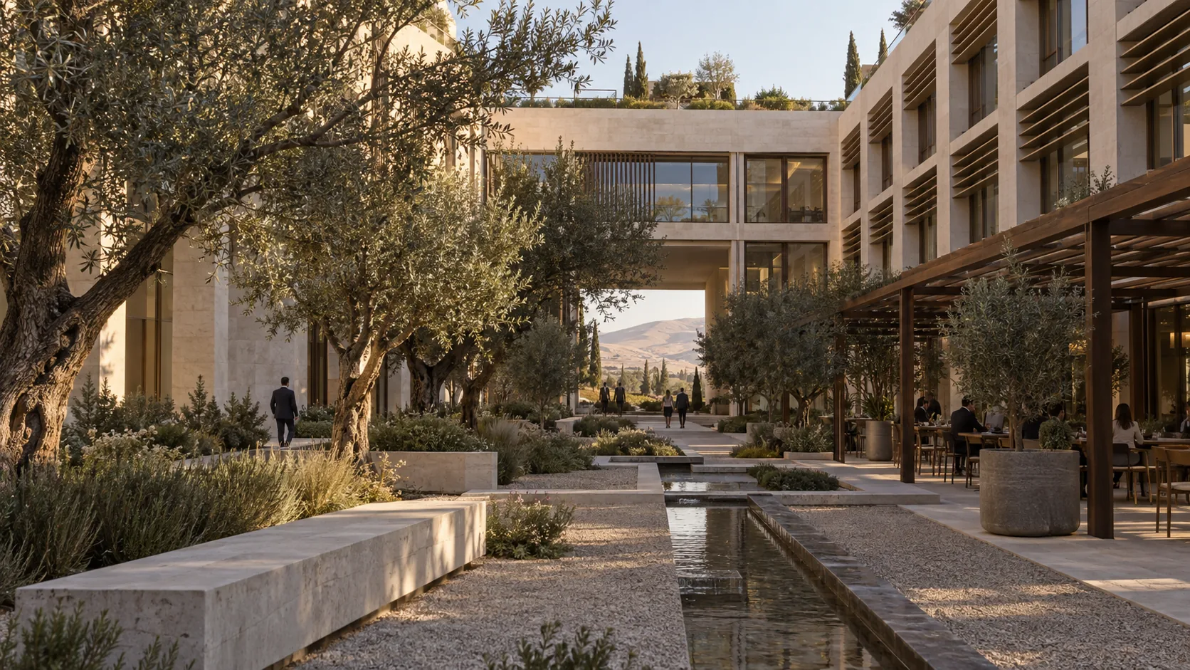 Concept: inside an office court — limestone façades with shading fins, olive trees, a stone water channel, a café terrace under a timber pergola, the hills beyond